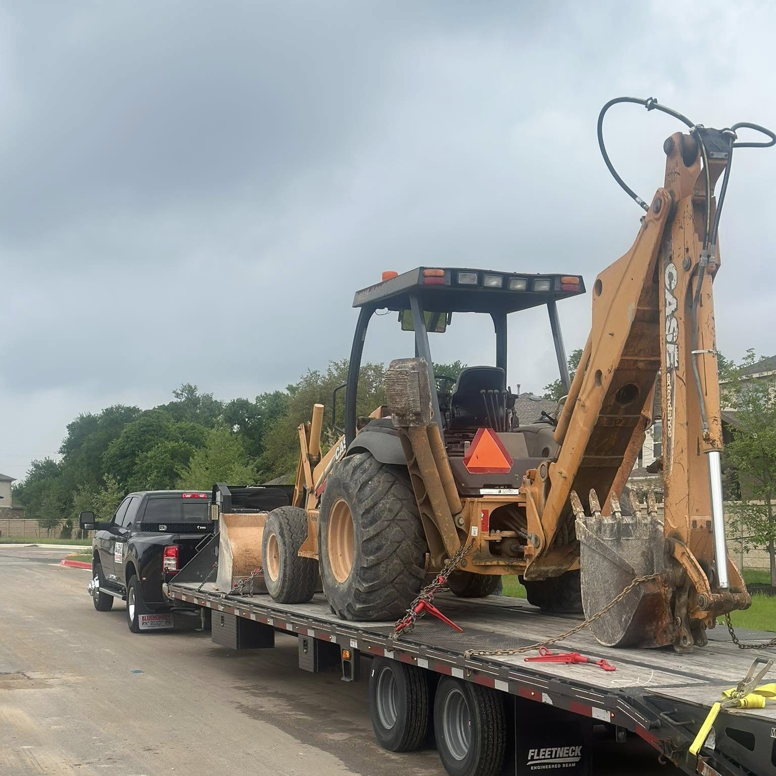 Excavator on flat bed for towing